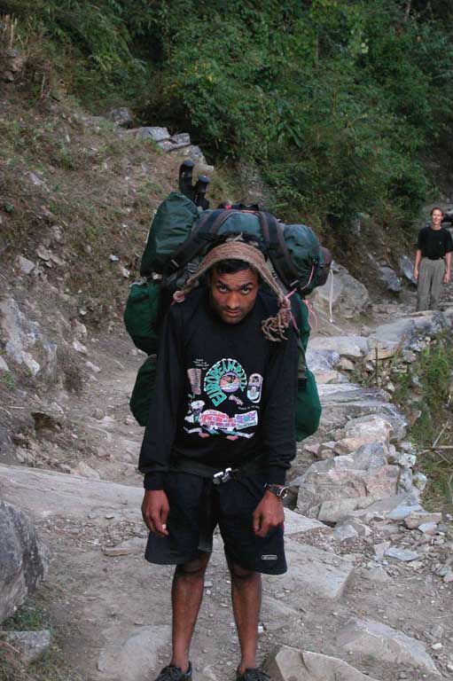 First porter carrying Rains pack